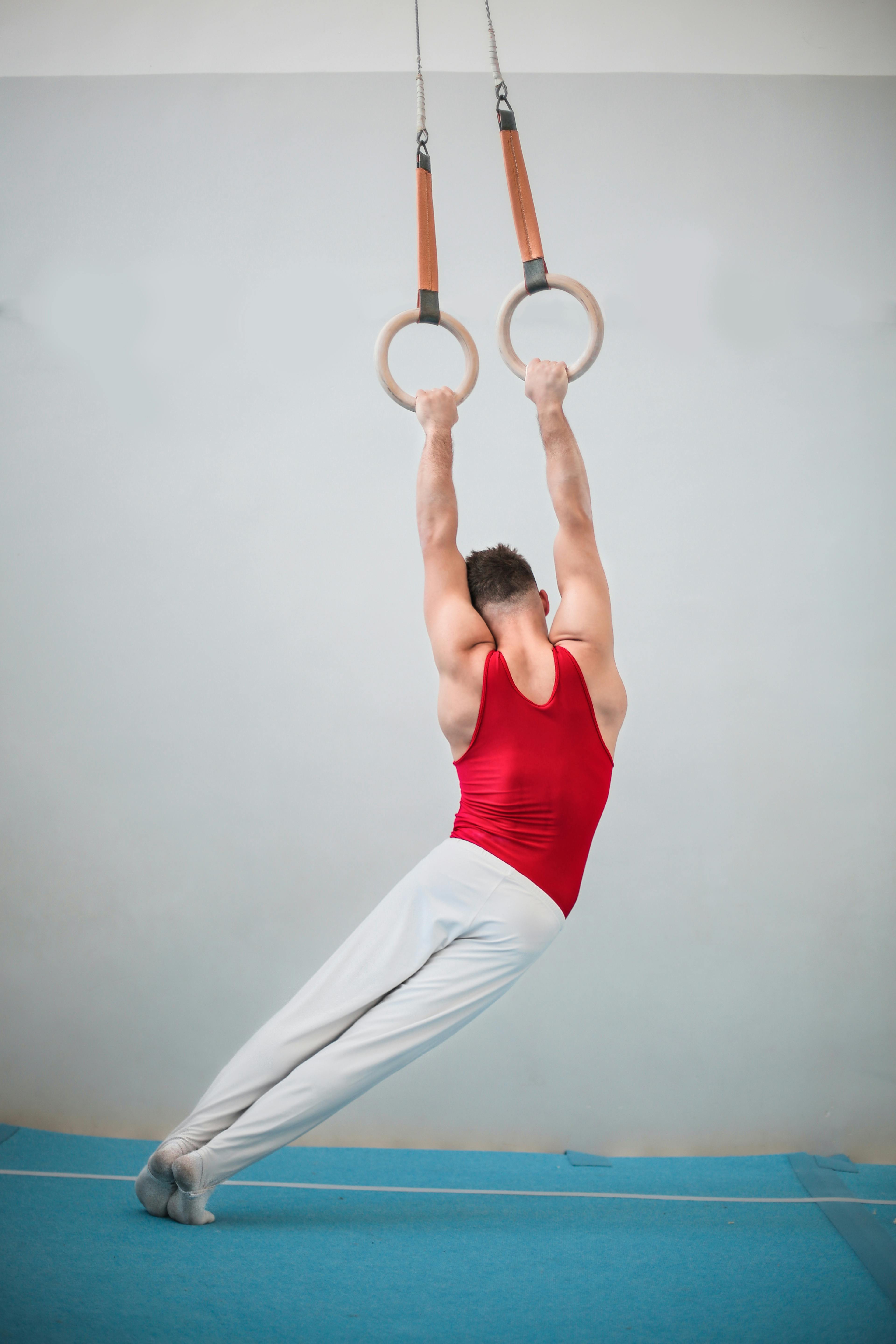 Teen practicing acrobatic skills with spotter